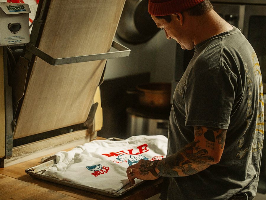 Checking print quality and color consistency on a bulk screen printing run