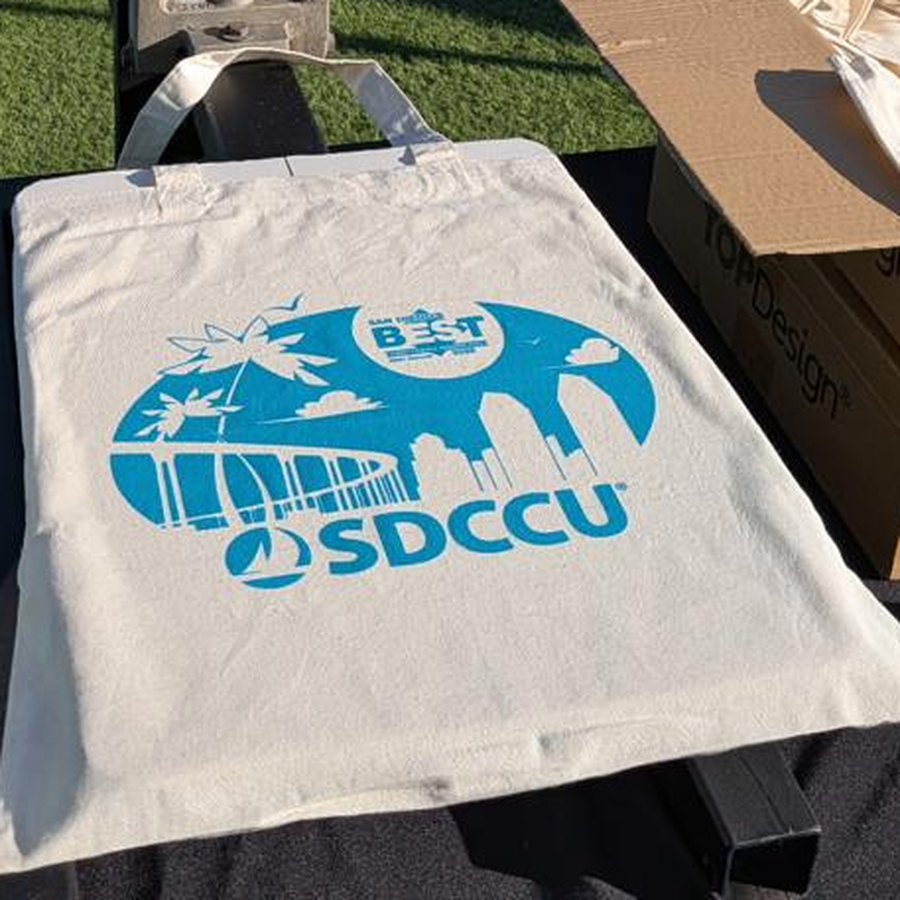 Custom printed tote bag on the press at a live printing event