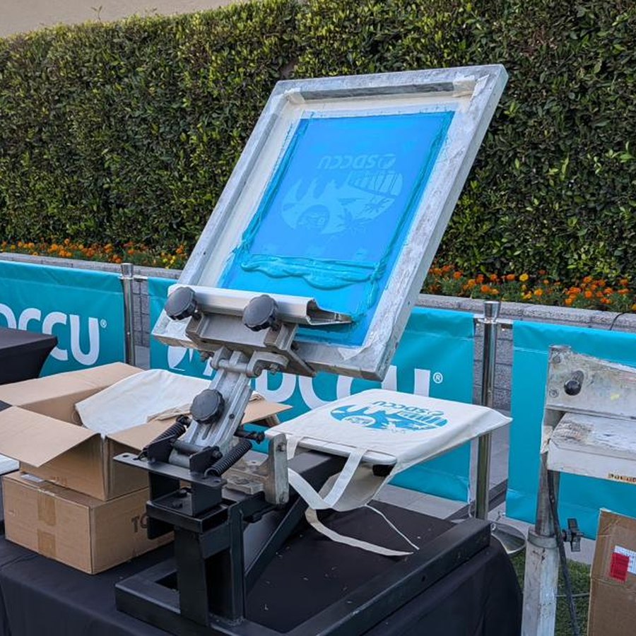 Live screen printing press set up at a corporate event in San Diego County